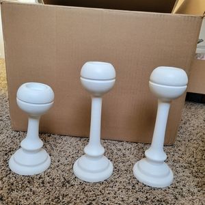 3 white candle stick holders